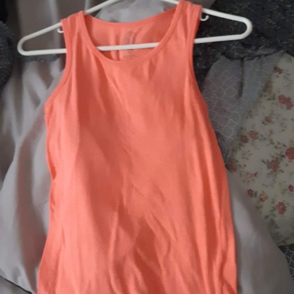 A long bright orange t-shirt. Brand :So